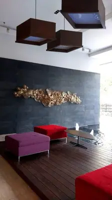 a living room with red and purple ottomans and a table at 2-Bedroom Apartment in Kuala Lumpur City Center in Kuala Lumpur