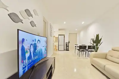 a living room with a large flat screen tv at Bukit Bintang Fairlane 1412 for 1-5pax 1BR TRX Pavilion KL in Kuala Lumpur