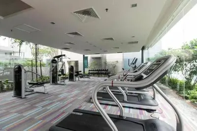a gym with a row of treadles on a treadmill at Prime Summer Suites KLCC in Kuala Lumpur