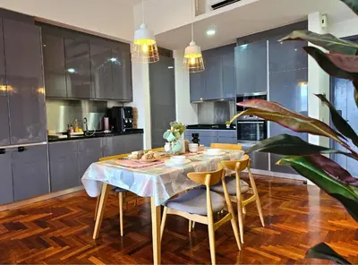 a kitchen with a table and chairs in a kitchen at The Mews Kuala Lumpur Homestay with Bathtub 700m to KLCC by Cloud Host in Kuala Lumpur