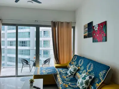 a living room with a couch and a large window at Regalia Residence By Willow Home in Kuala Lumpur