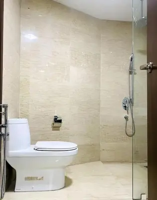 a bathroom with a toilet and a glass shower at Regalia Residence By Willow Home in Kuala Lumpur