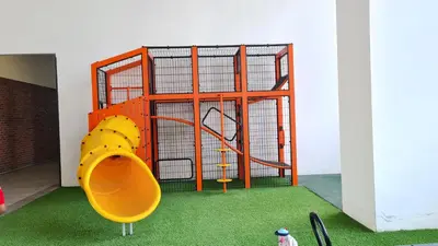 a play structure with a slide and a playground at Chambers Suites KLCC By Glory Homes in Kuala Lumpur