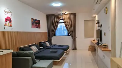 a living room with two beds and a couch at Chambers Suites KLCC By Glory Homes in Kuala Lumpur