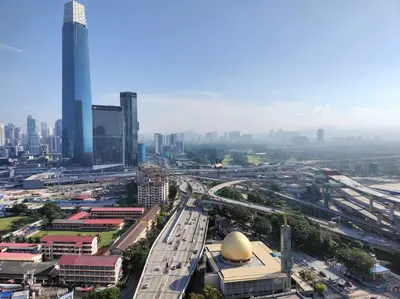 a city with a busy highway and a city with tall buildings at Continew TRX Corner 2-BR, 2 Balconies City Views in Kuala Lumpur