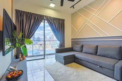 a living room with a couch and a large window at Continew TRX Corner 2-BR, 2 Balconies City Views in Kuala Lumpur