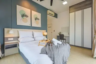a bedroom with a large white bed and a table at Continew TRX Corner 2-BR, 2 Balconies City Views in Kuala Lumpur