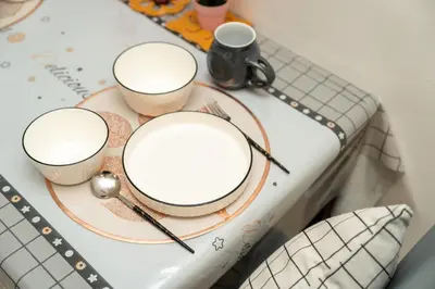 a table with two plates and two cups on it at Twin Towers Suites - 7mins walking to KLCC in Kuala Lumpur