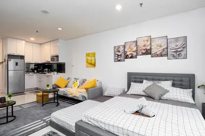 a bedroom with a bed and a living room at Twin Towers Suites - 7mins walking to KLCC in Kuala Lumpur