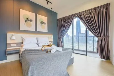a bedroom with a bed and a large window at Continew TRX Corner Dual Balconies 2 Bedrooms in Kuala Lumpur