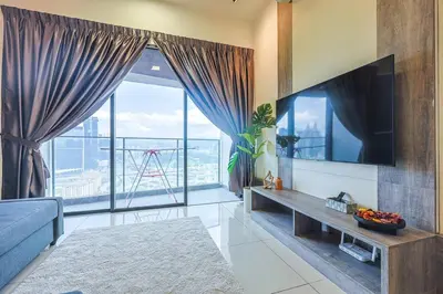 a living room with a tv and a large window at Continew TRX Corner Dual Balconies 2 Bedrooms in Kuala Lumpur
