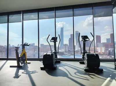 a gym with cardio machines in front of a large window at Continew TRX Corner Dual Balconies 2 Bedrooms in Kuala Lumpur