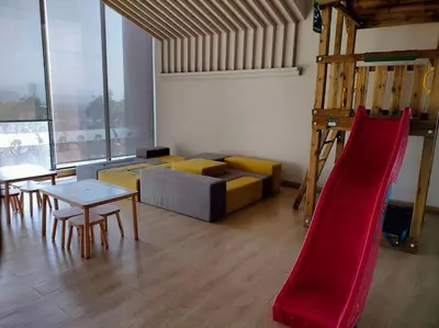 a living room with a couch and a slide at Continew TRX Corner Dual Balconies 2 Bedrooms in Kuala Lumpur
