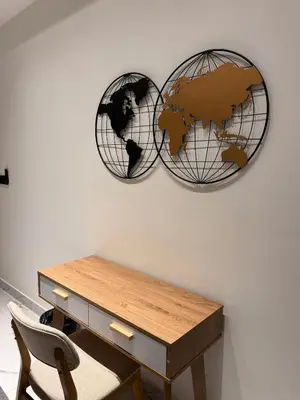 two metal spheres on a wall with a desk at Alfa Bangsar by City Keys in Kuala Lumpur