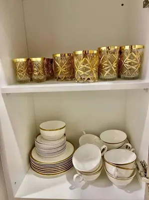 a shelf with plates and bowls in a kitchen at Trion Kuala Lumpur KLCC view L65 2br 2bth in Kuala Lumpur