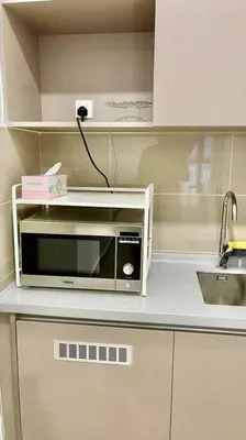 a microwave sitting on top of a kitchen counter at Trion Kuala Lumpur KLCC view L65 2br 2bth in Kuala Lumpur