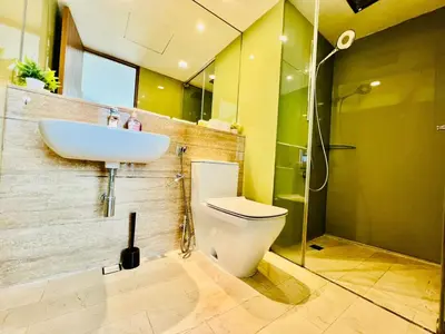 a bathroom with a white toilet and a sink at KLCC Vortex Suites Residence in Kuala Lumpur