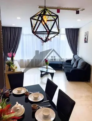 a living room with a black table and chairs at KLCC Vortex Suites Residence in Kuala Lumpur