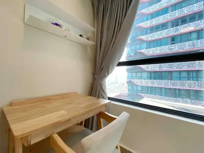 a table and chairs in a room with a window at Arte plus by dream stay in Kuala Lumpur