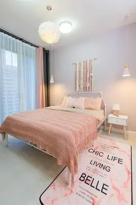 a bedroom with a bed with a pink blanket at My home at Kuala Lumpur in Kuala Lumpur
