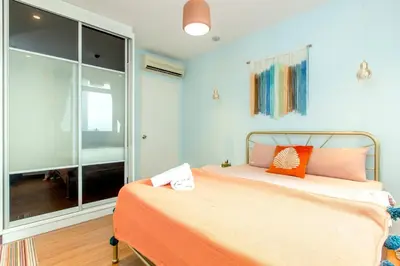 a bedroom with a bed and a large window at My home at Kuala Lumpur in Kuala Lumpur