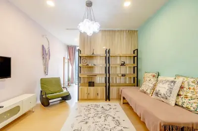 a living room with a bed and a tv and a chair at My home at Kuala Lumpur in Kuala Lumpur