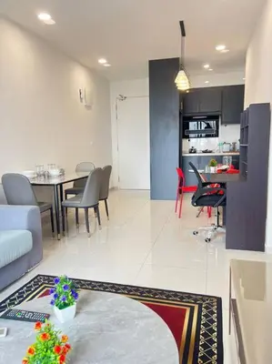 a living room and kitchen with a table and chairs at Cozy kenwingston platz kl 2-5pax 2BR&2BR Klcc view pakin netflx 3705A in Kuala Lumpur