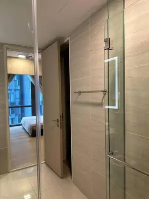 a bathroom with a glass shower and a bedroom at Cozy Comfy & Affordable Place at KLCC in Kuala Lumpur