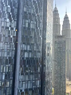 a tall building with many windows in a city at Cozy Comfy & Affordable Place at KLCC in Kuala Lumpur