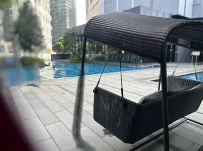 a swing sitting on top of a building with a pool at Cozy Comfy & Affordable Place at KLCC in Kuala Lumpur