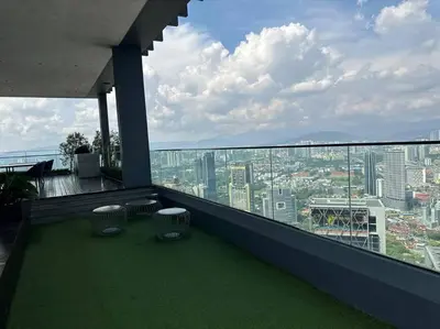 a balcony with two chairs and a view of a city at Cozy Comfy & Affordable Place at KLCC in Kuala Lumpur