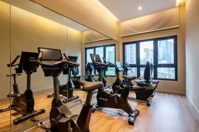 a gym with treadmills and exercise bikes in a room at Maxhome-Agile Bukit Bintang TRX in Kuala Lumpur