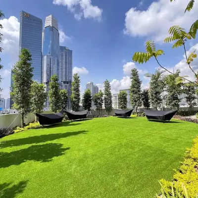 a large grassy field with a city in the background at Maxhome-Agile Bukit Bintang TRX in Kuala Lumpur