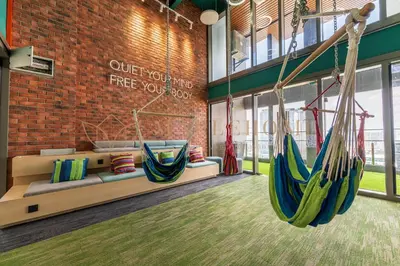 a room with two hammocks in a building at Riveria Premier Suites Kuala Lumpur in Kuala Lumpur