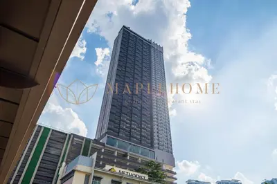 a tall building with a sign on the side of it at Riveria Premier Suites Kuala Lumpur in Kuala Lumpur