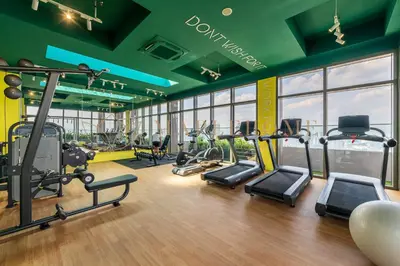 a gym with several treadmills and elliptical machines at Riveria Premier Suites Kuala Lumpur in Kuala Lumpur