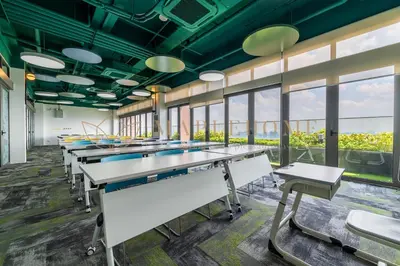 a row of tables in a room with windows at Riveria Premier Suites Kuala Lumpur in Kuala Lumpur