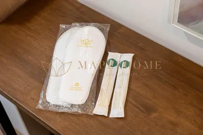 a wooden table with a new arrive bag and scissors at Riveria Premier Suites Kuala Lumpur in Kuala Lumpur