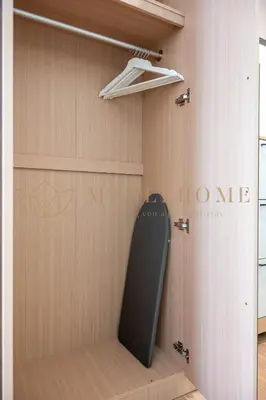 a room with a closet with a door and a sign at Riveria Premier Suites Kuala Lumpur in Kuala Lumpur