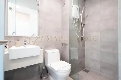 a bathroom with a shower and a toilet and a sink at Riveria Premier Suites Kuala Lumpur in Kuala Lumpur