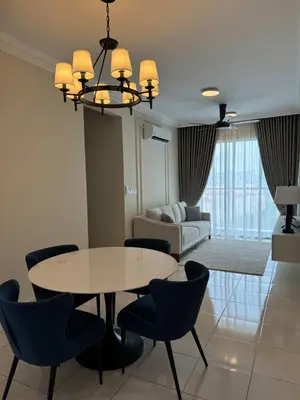 a living room with a table and chairs and a couch at Naaa homee in Kuala Lumpur