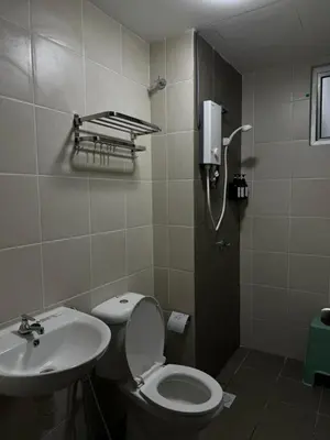 a bathroom with a toilet and a sink at Naaa homee in Kuala Lumpur