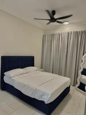 a bedroom with a bed with a ceiling fan at Naaa homee in Kuala Lumpur