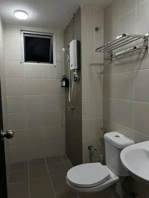 a bathroom with a toilet and a shower and a sink at Naaa homee in Kuala Lumpur