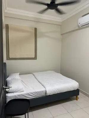 a bedroom with a bed with a ceiling fan at Naaa homee in Kuala Lumpur