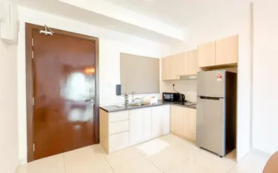 a kitchen with a brown door and a refrigerator at Inspirasi at Mont Kiara by Airhost in Kuala Lumpur