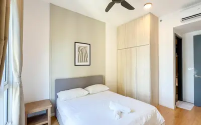 a bedroom with a white bed and a ceiling fan at Inspirasi at Mont Kiara by Airhost in Kuala Lumpur