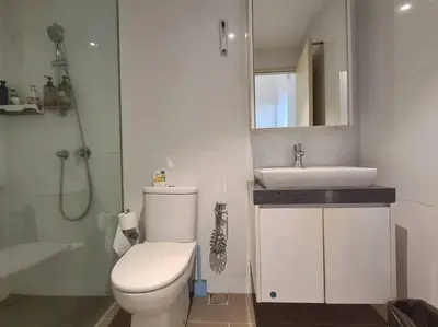 a white bathroom with a toilet and a sink at SkyView Studio, EST Bangsar, High View for 2 in Kuala Lumpur