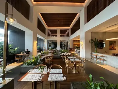 a restaurant with tables and chairs and people sitting at tables at SkyView Studio, EST Bangsar, High View for 2 in Kuala Lumpur
