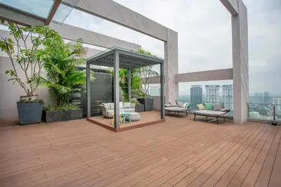 an outdoor deck with furniture on a building at Riveria City near KL Sentral with 118 view Sky Infinity Pool by COBNB in Kuala Lumpur
